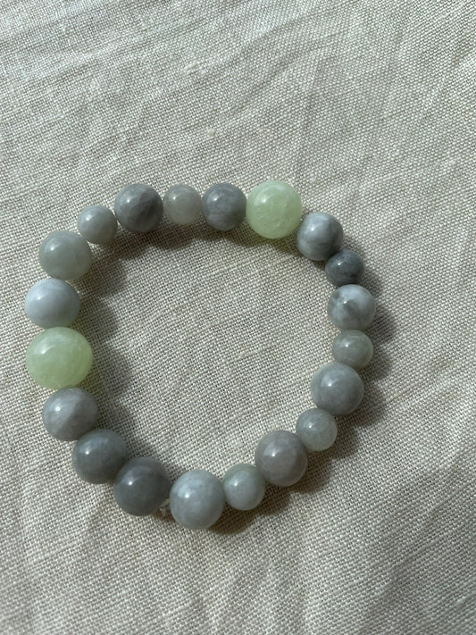 Ocean Calm natural gemstone bracelet arranged in a circle, featuring blue, grey and green natural gemstones.
