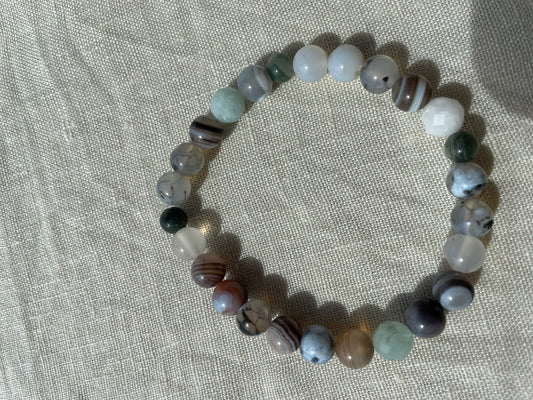 Forest Coast natural gemstone bracelet arranged in a circle, featuring green, blue, white and earthy brown gemstone beads.