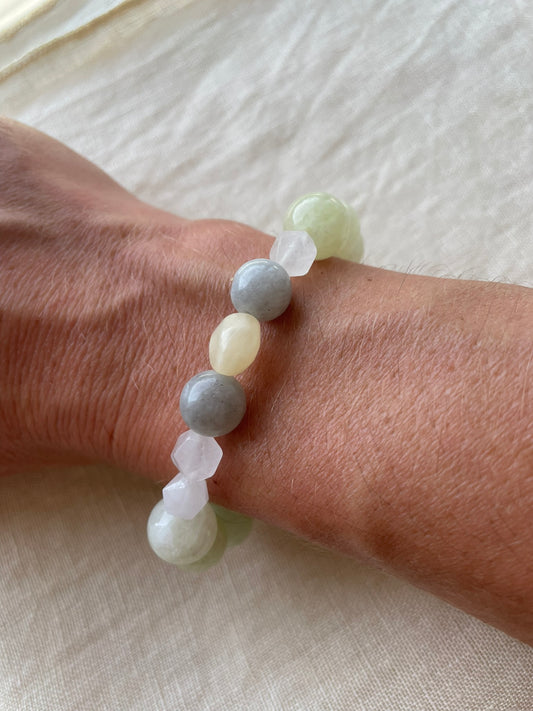 Serene Balance natural gemstone bracelet worn on the wrist, featuring soft green, misty blue, creamy white and warm natural tones.