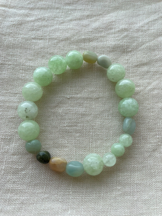 Green Harmony natural gemstone bracelet arranged in a circle, featuring polished green and blue-green gemstones.