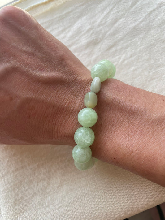 Green Harmony natural gemstone bracelet in soft green and blue-green tones worn on the wrist.