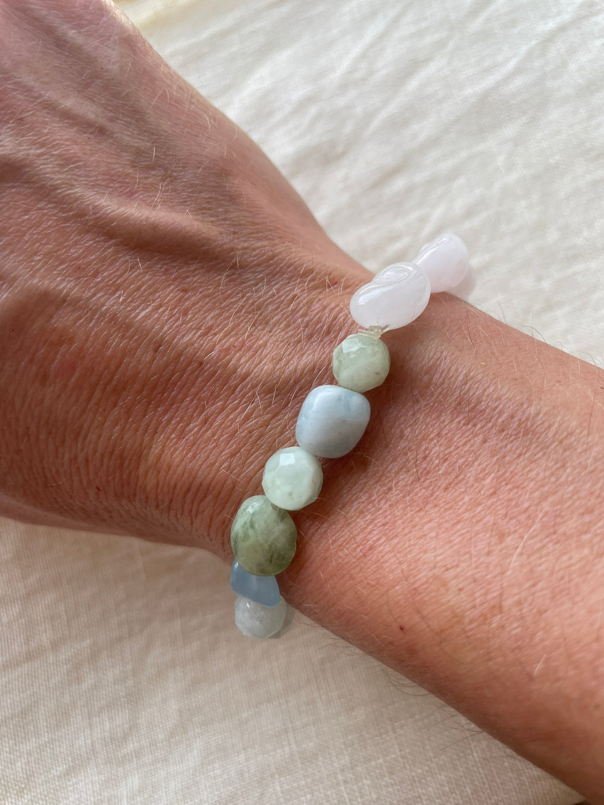 Pastel Serenity natural gemstone bracelet worn on the wrist, showing its delicate pastel gemstone colours.