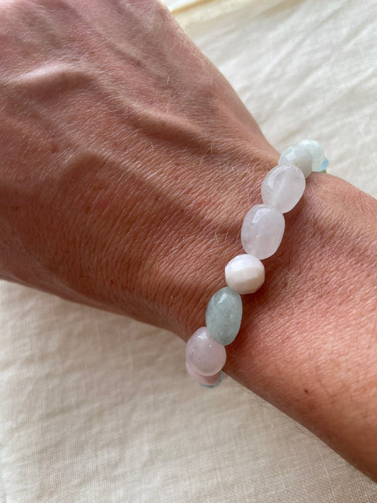 Pastel Serenity natural gemstone bracelet in soft pink, white, blue and green tones worn on the wrist.