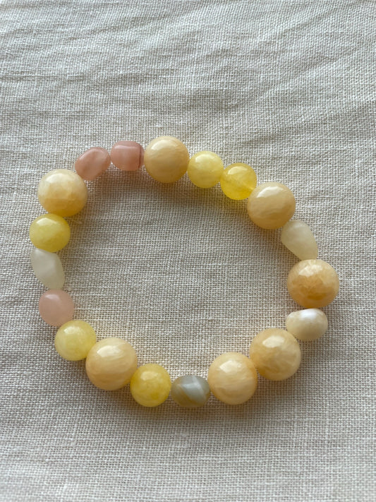 Golden Sunrise natural gemstone bracelet arranged in a circle, showing warm honey, peach and cream gemstones.