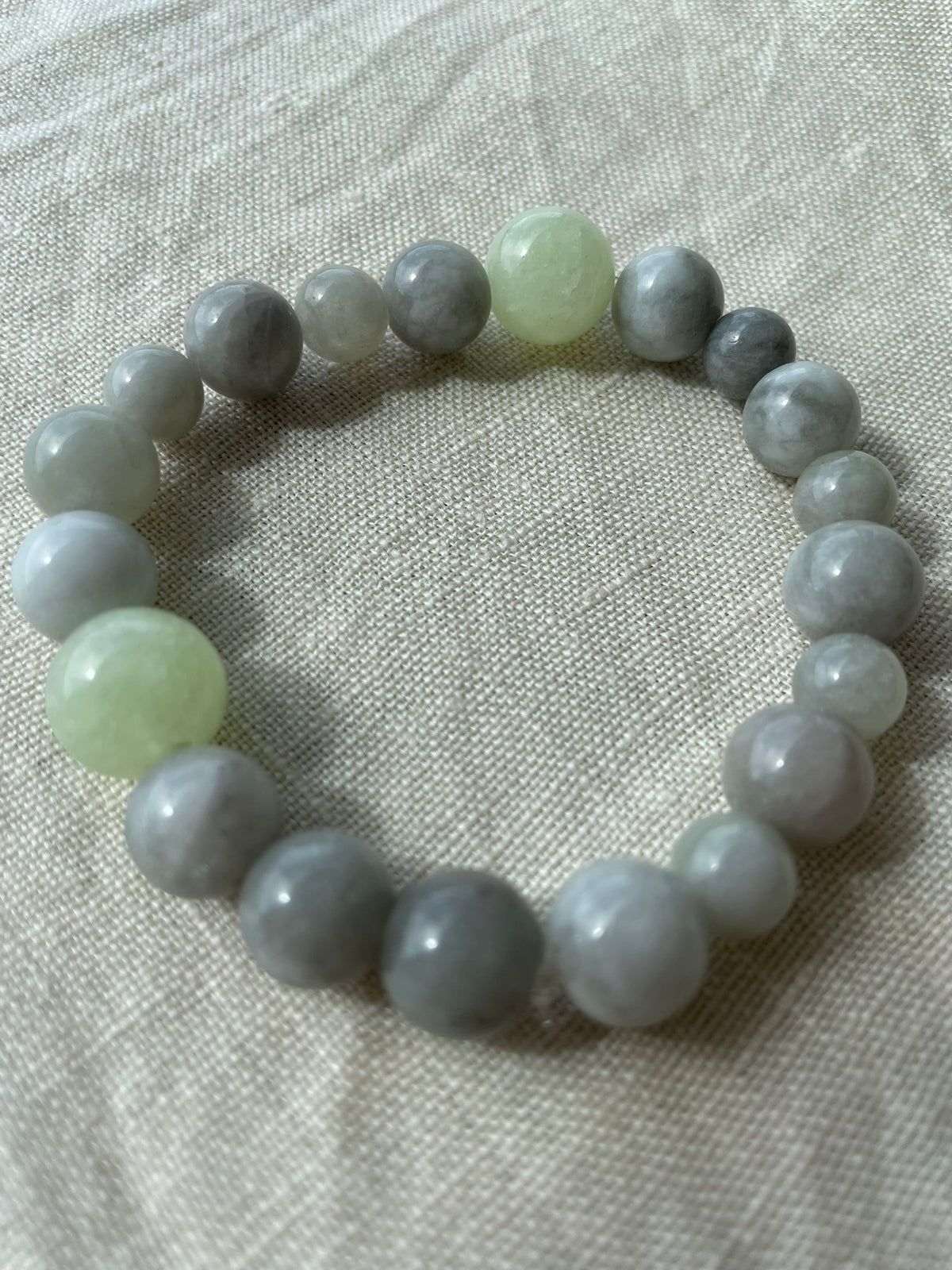 Close-up of the Ocean Calm gemstone bracelet showing its polished blue, grey and green gemstones.
