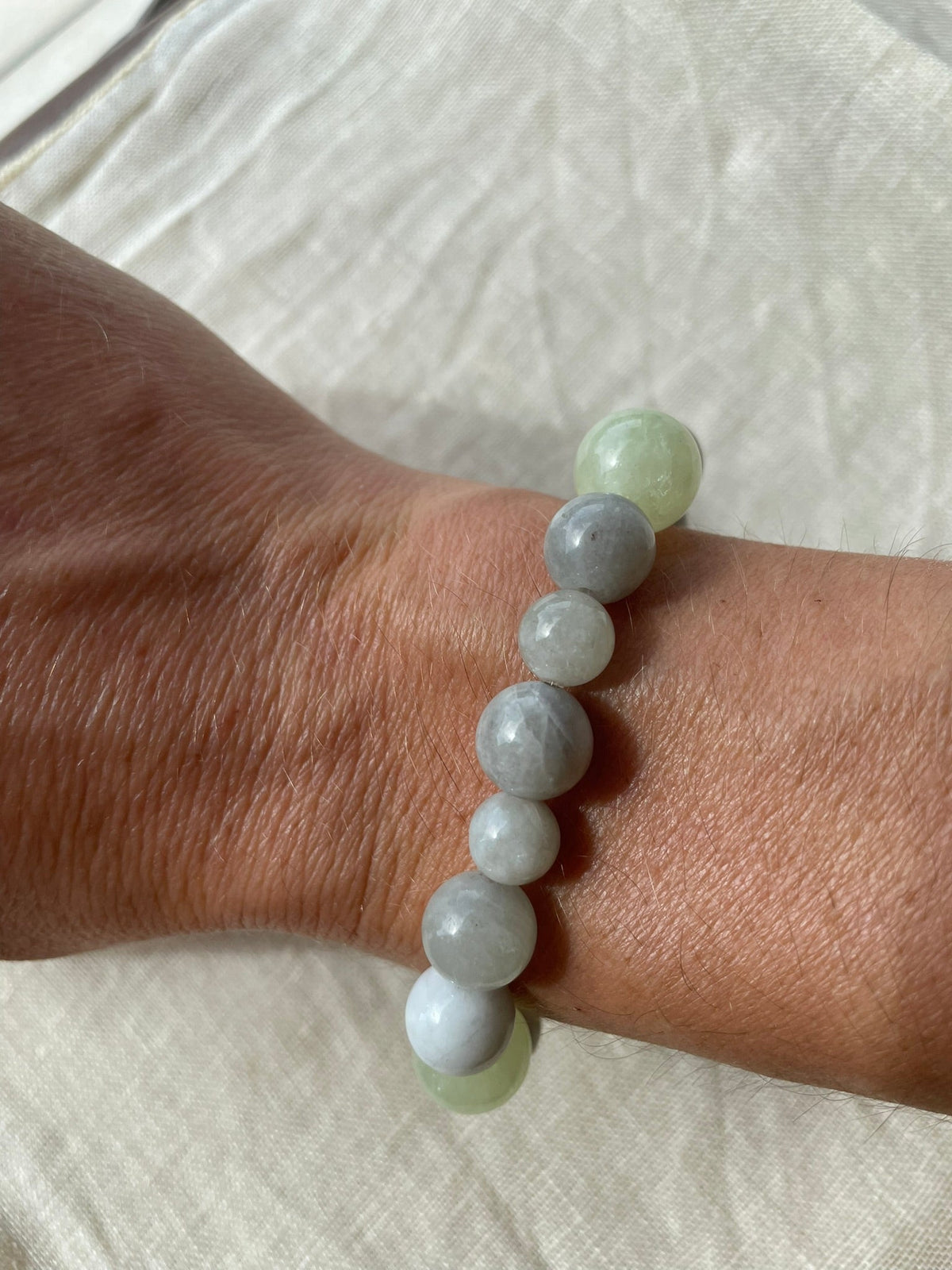 Ocean Calm gemstone bracelet worn on the wrist, highlighting the natural blue, grey and green tones.