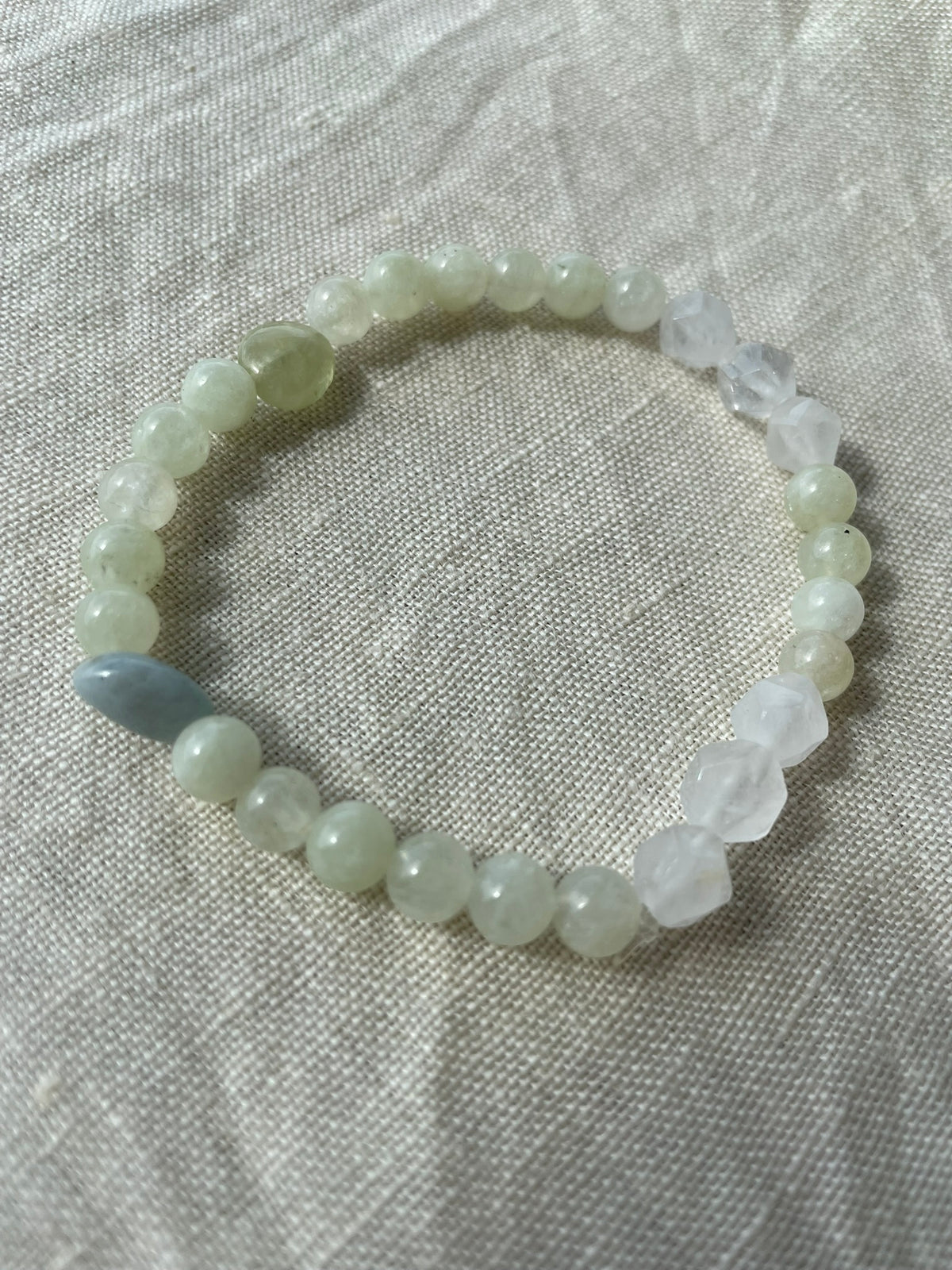 Close-up view of the Misty Meadow gemstone bracelet showing its natural green, white and misty blue gemstones.