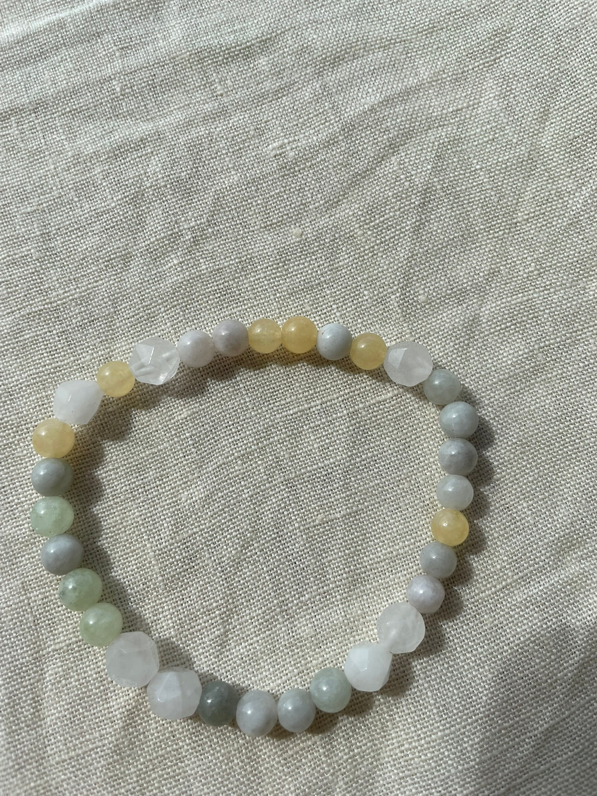 Yellow Forest natural gemstone bracelet arranged in a circle, showing Moss Agate, Green Aventurine and Dendritic Agate stones.