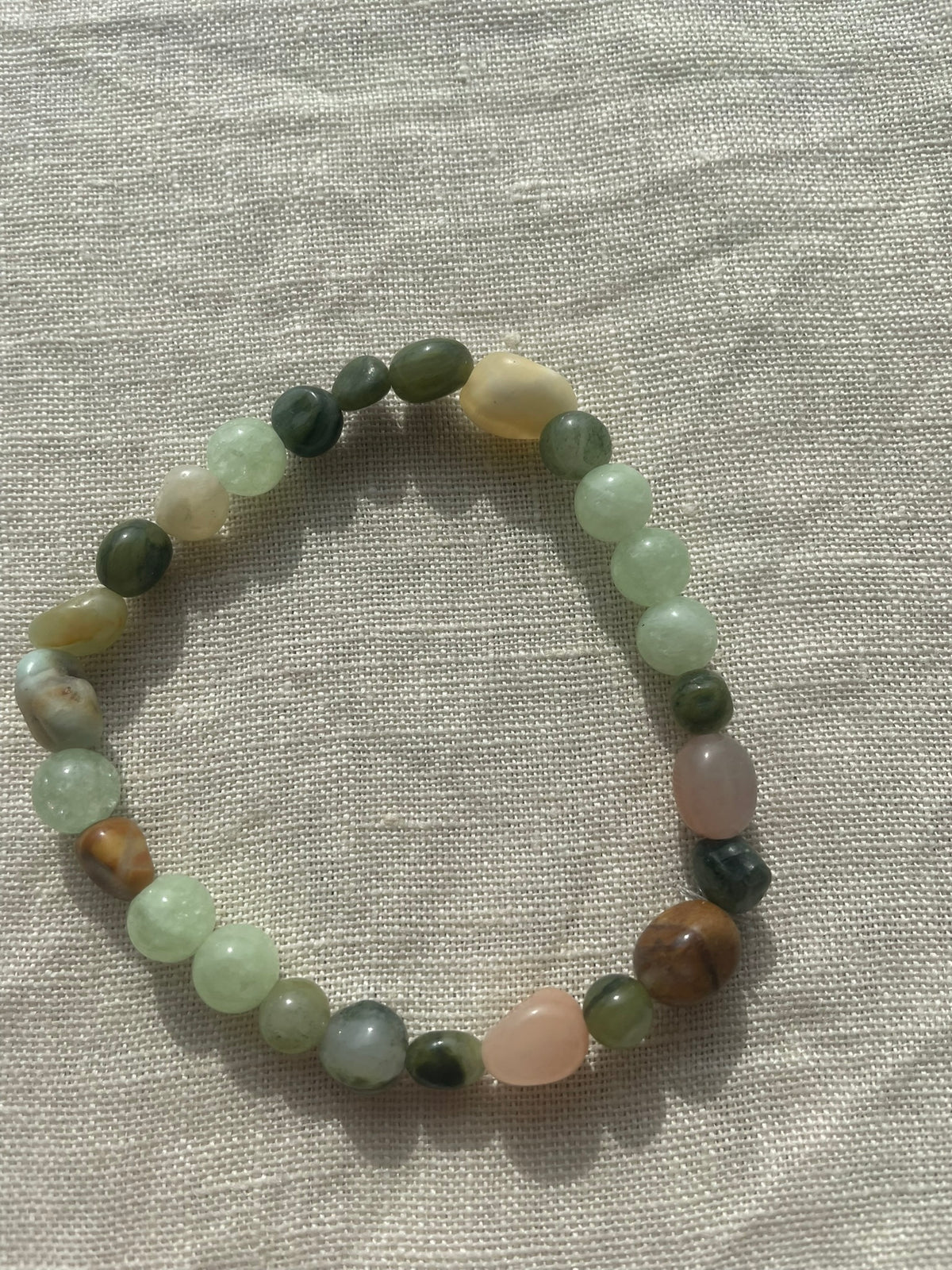 Forest Garden natural gemstone bracelet arranged in a circle, featuring soft green, white and earthy brown gemstone beads.