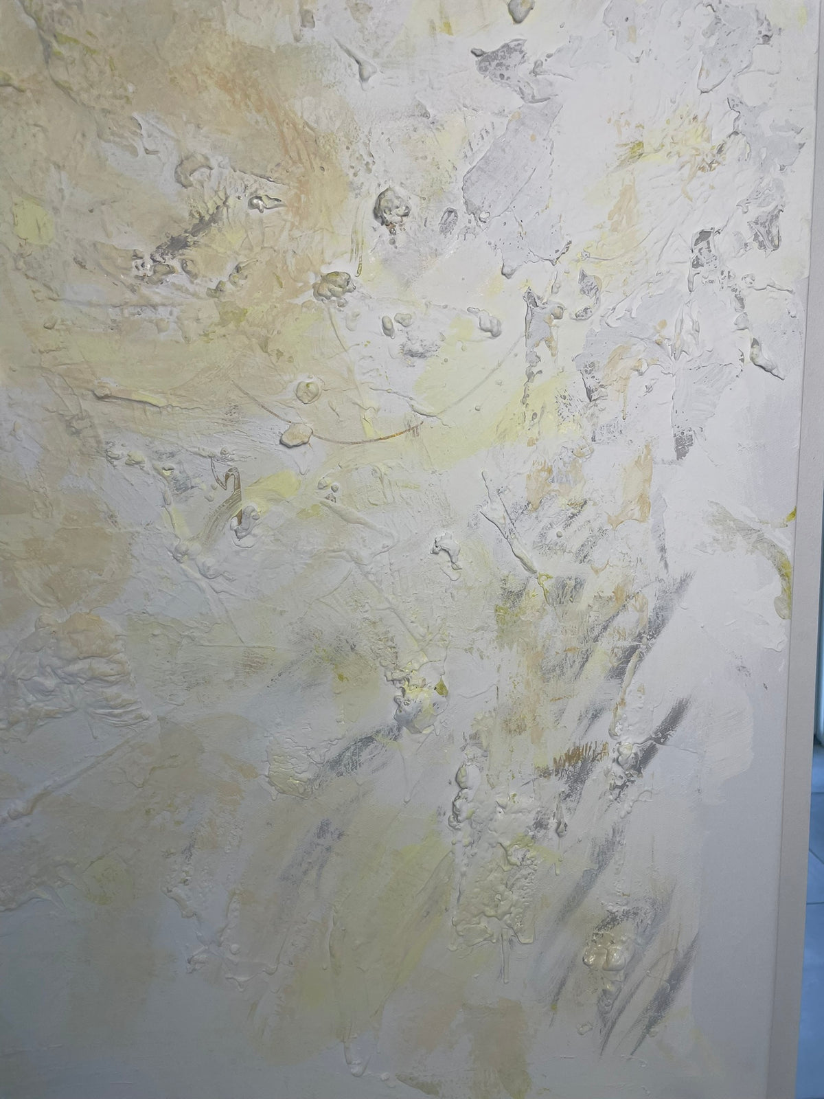 Whispers of Light original abstract painting by Victoria Lorenz displayed above a console in an elegant neutral-toned interior, featuring soft white, ivory, beige and muted golden textures