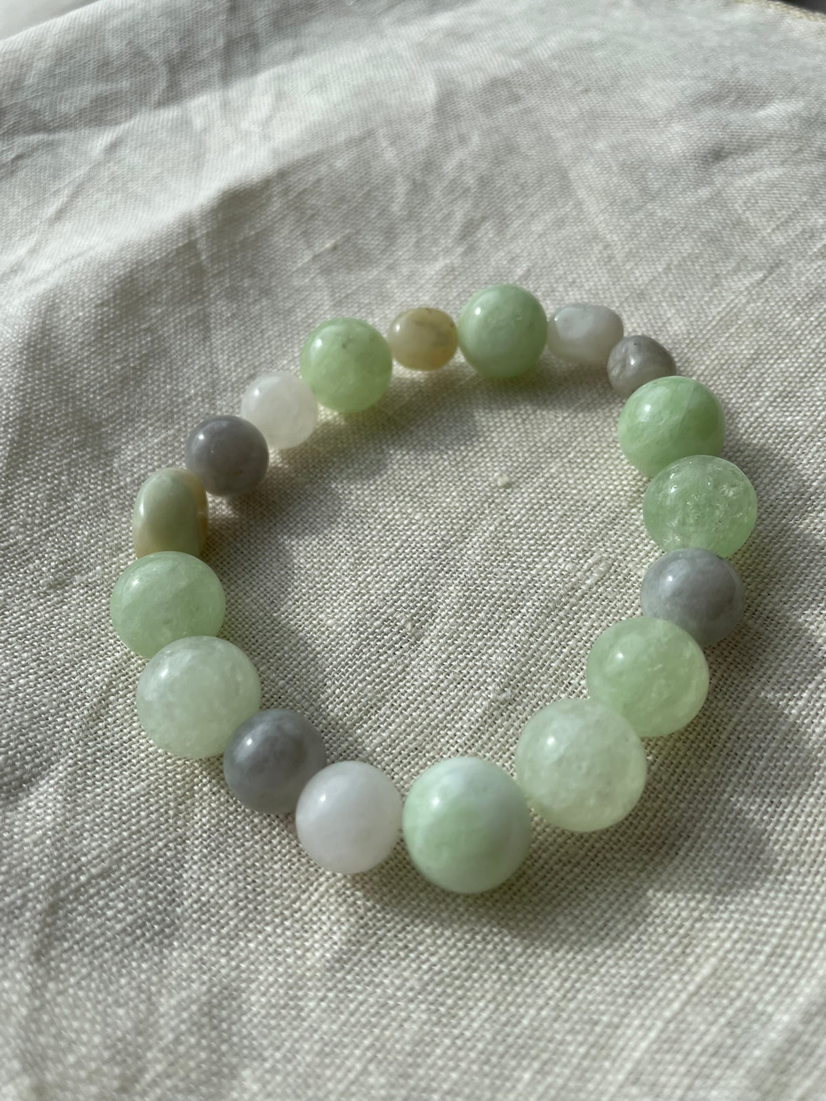 Close-up of the Soft Green Harmony bracelet showing natural green, white and grey gemstone beads.