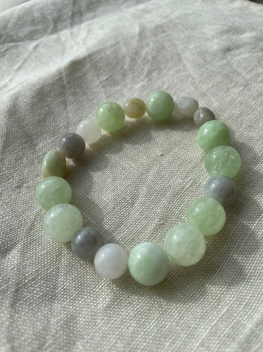 Close-up of the Soft Green Harmony bracelet showing natural green, white and grey gemstone beads.