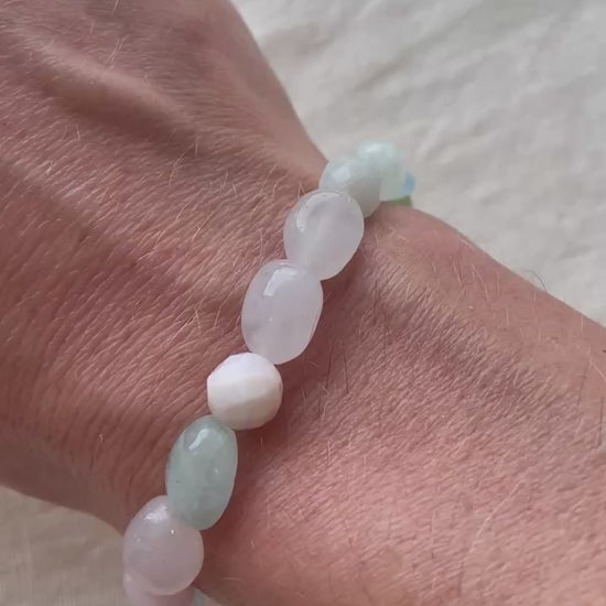 Video showing the Pastel Serenity handmade natural gemstone bracelet with soft pastel pink, white, blue and green gemstones.