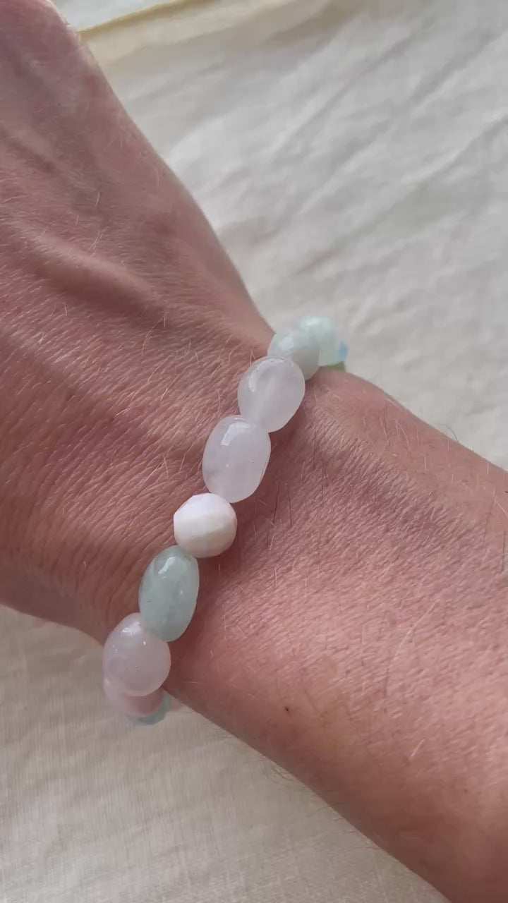 Video showing the Pastel Serenity handmade natural gemstone bracelet with soft pastel pink, white, blue and green gemstones.