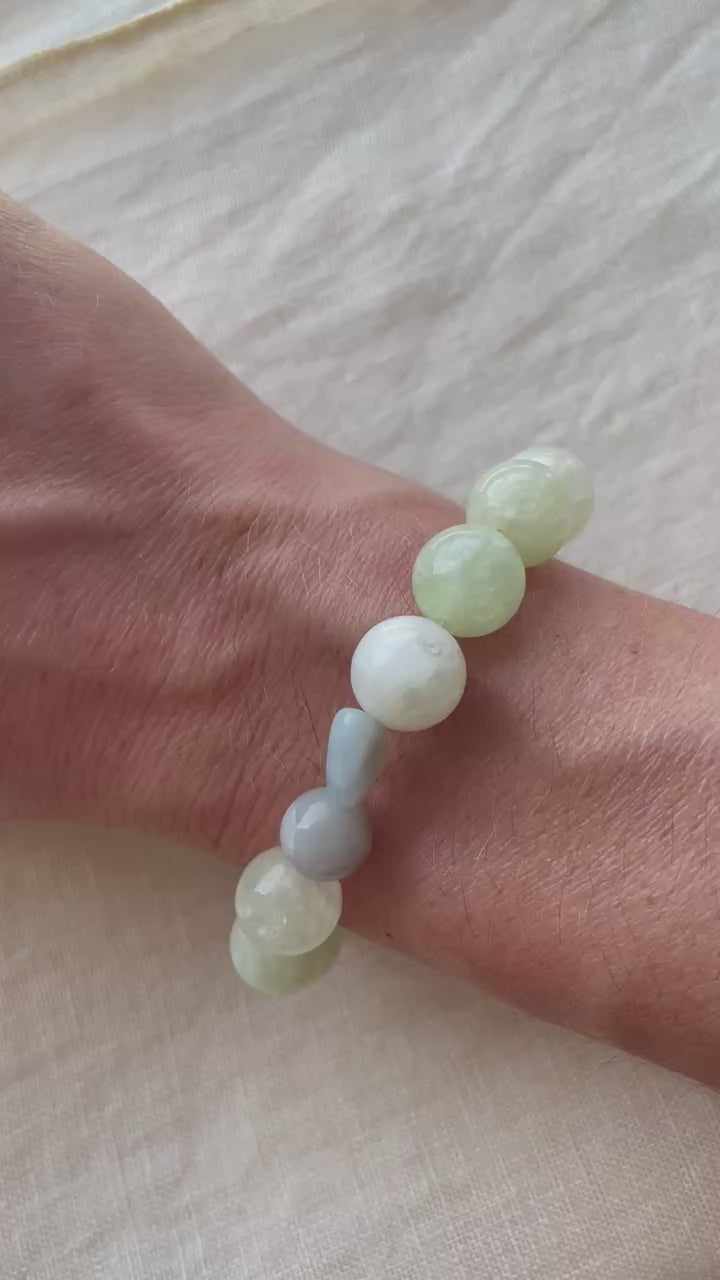 Video showing the Serene Balance handmade natural gemstone bracelet with soft green, misty blue, creamy white and natural tones.